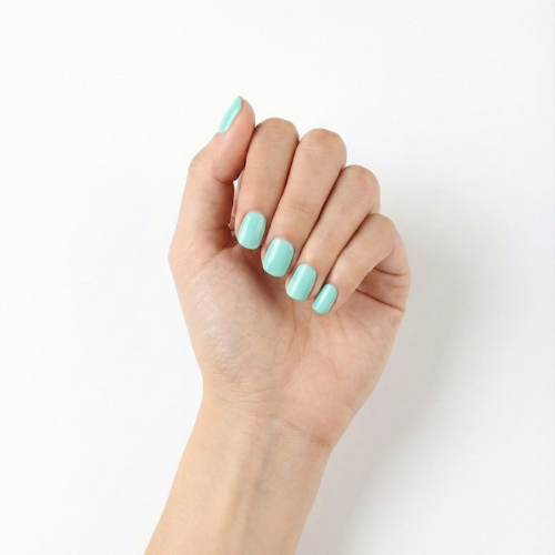 Hand wearing Alice pastel aqua nail polish wraps