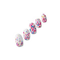 Petulia pearlescent white confetti nail polish wraps with multicoloured petal-shaped spots shown on five nail tips