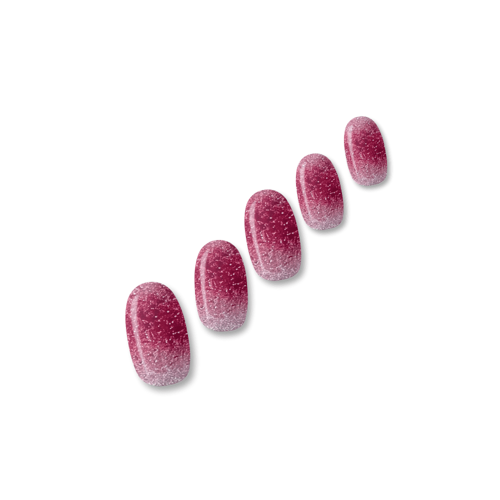Reno glitter ombre nail polish wraps fading from silver through rosy pink to cranberry red shown on five nail tips