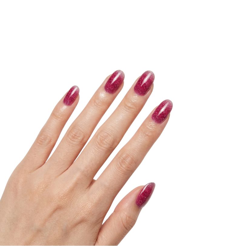 Hand wearing Reno cranberry red and rosy pink glitter ombre nail polish wraps