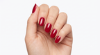 Hand wearing Ruby Ruby Ruby glossy true red nail polish wraps
