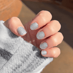 Close-up of fingers wearing Shimmer silver glitter nail polish wraps
