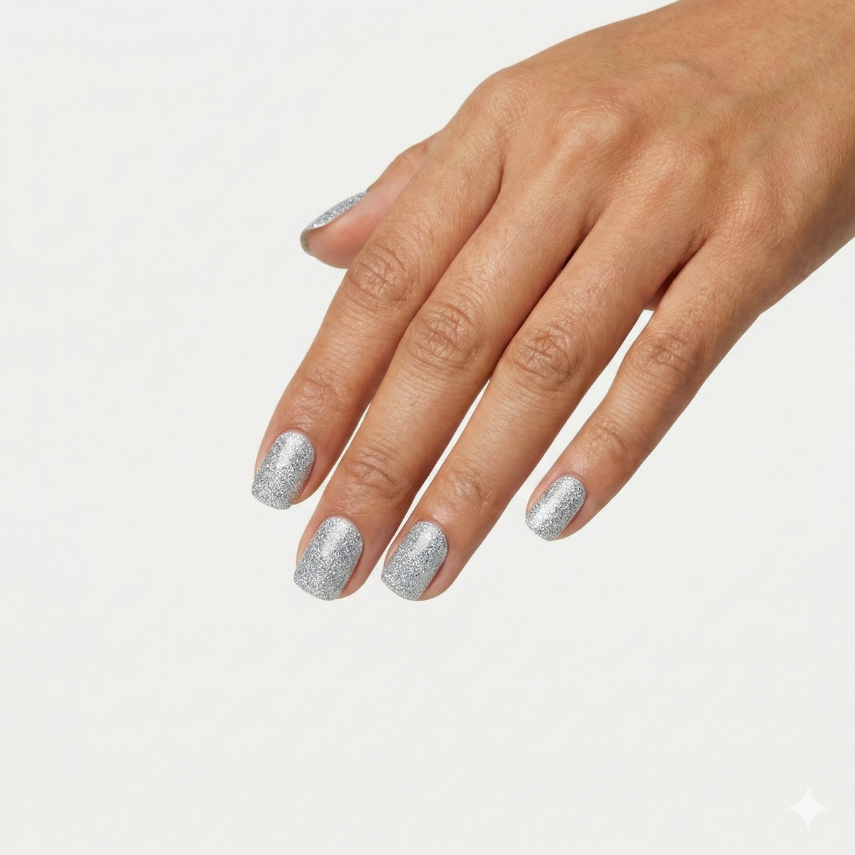 Hand wearing Shimmer silver glitter nail polish wraps