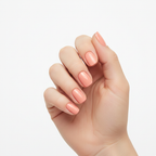 Hand wearing Tutu glossy soft peachy-pink nail polish wraps