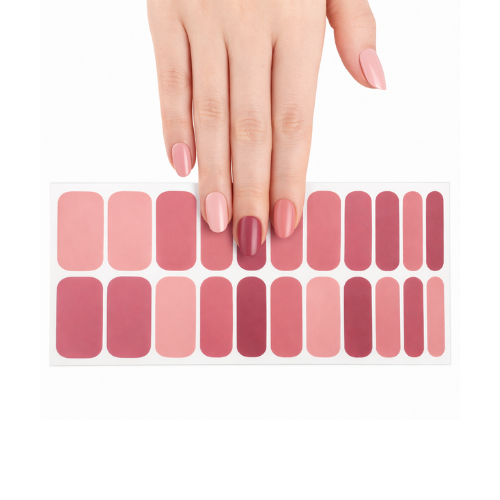 Hand wearing Autumn Pinks nail polish wraps above the 22-strip wrap sheet